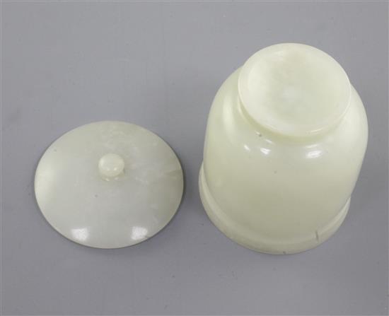 A Chinese pale celadon jade jar and cover, 19th / early 20th century, height 7.8cm, two colour wood stand